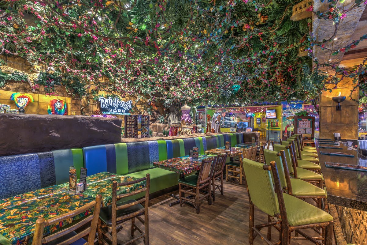 a dining area filled with furniture decorated like a jungle